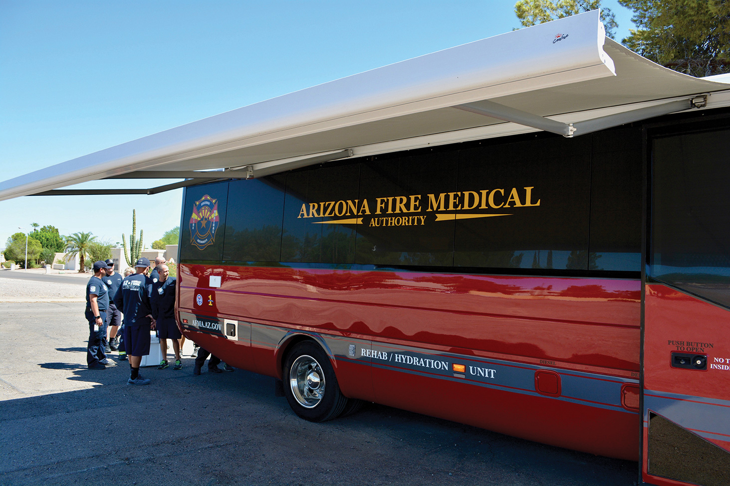 AFMA/Sun Lakes firefighters familiarize themselves with the new rehabilitation and rehydration unit in front of Station 231 on Sun Lakes Boulevard. (Photo by Brian Curry)