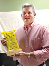 Retired U.S. Air Force Lt. Gen. Rusty Findley displays one of the humanitarian ration packets signed by crewmembers following a presentation to the Sun Lakes Aero Club gathering April 17. Photo by Gary Vacin.