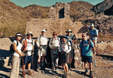 Hikers posing in front of ruins in South Mountain Park.
