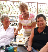 Barb Hansen serving Lynda Smith and Marci Koppelmaa.