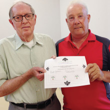 Dick Hensley (left) received a certificate from Lucky shot Pool Club President Mike Giarlo certifying 4,190 tournament games played at the club’s spring awards luncheon April 22. Hensley has announced his retirement from tournament play in the club.