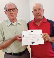 Dick Hensley (left) received a certificate from Lucky shot Pool Club President Mike Giarlo certifying 4,190 tournament games played at the club’s spring awards luncheon April 22. Hensley has announced his retirement from tournament play in the club.