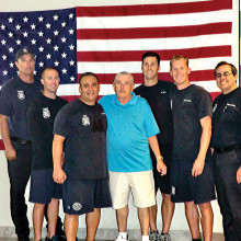 Surrounding Mr. Marr in the blue shirt is the lifesaving crew (left to right) firefighter Tom Geffert, firefighter Ricky Quinn, paramedic Les Legarreta, firefighter Brent Kohl, engineer David DeGraaf and Captain Robert Olmstead. Mr. Marr said, “These men are my heroes.”
