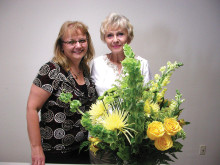 Barbara Renee Oliver, owner of Flowers by Renee (left) is pictured with the beautiful arrangement she designed and Sun Lakes Garden Club member Jana Matousek, who won it.