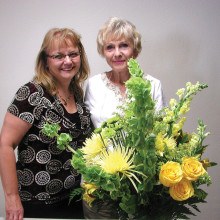 Barbara Renee Oliver, owner of Flowers by Renee (left) is pictured with the beautiful arrangement she designed and Sun Lakes Garden Club member Jana Matousek, who won it.