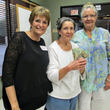 Sherrian Beagle of the Women’s Exchange Group presents Lee and Dee of Rovers Rest Stop Dog Rescue with a cash donation from the group’s July meeting. The Women’s Exchange also donates to help homeless women. Right now the group is holding a sock drive as part of fall/holiday projects coming in the near future.