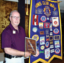 District Governor Elect Lion Larry Palmer of the Sun Lakes Lions Club proudly stands by one of the club’s banners with his “Lion of the Year” award plaque. Presented by Club President Forrest Cheuvront earlier, Lion Larry stands out in how he follows the Lions Motto of “We Serve.” He will be sworn in as District Governor of Arizona’s 21-B in July at the International Lions Clubs Convention held in Toronto Canada.