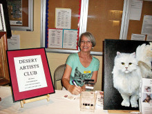 Shirley Shoemaker and her White Cat encourage local artists to join the Desert Artist’s Club!