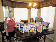 VFW Auxiliary President Betty Peer and Veterans and Family Support Chair Sandra Whittenberg with educational materials purchased for children of the adopted Guard unit member who was killed in an auto accident.