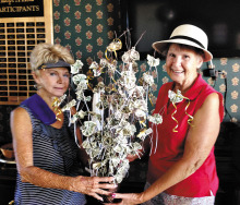 Barbara DeNapoli presenting El Hinerichsen a money tree in celebration of her August wedding.