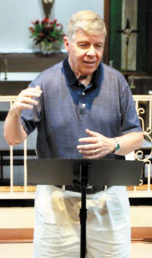 Bill Bade directs Risen Savior Church Choir during rehearsal.