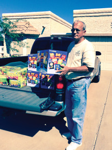 Pictured is Tom Whittenberg, Junior Vice-Commander, Sun Lakes VFW Post 8053, helping unload a truck full of drinks, snacks and goody bags which VFW Auxiliary Post 8053 provided to the many youth participating in Operation Kids held at Luke Air Force Base on October 25.