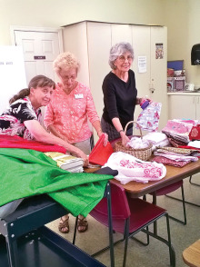 Pictured left to right are Johnnie Schofield, Rose Zimmer and Vickie Buholz going through some of the items we received this month. Photo by Viv Sloane.