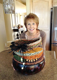 Guest artist is member Kathy Olds showing her woven basket with a gourd base. It includes seagrass, wool, reeds and beads. The other basket uses several mediums include woodburning and alcohol stain with a woven seagrass top. The inlay is a piece of art from the De Grazia museum.