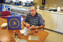 A candid photograph of Dick Thiel making a mold for a class.