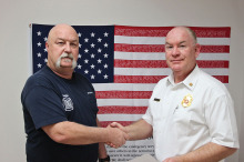 Captain Brad Rock is congratulated by Chief of Department Paul Wilson