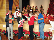 San Tan Crown Rotary members Bob Craft, Barbara Brooks, Joann Knutson and James Kame pass out Christmas cards and Rudolph candy canes at the Sunshine Residential Homes annual Christmas party.