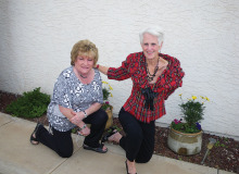 Paula Lauer (left) and Debby McDonald (right) in front of potted plants taken care of by the Sun Lakes Garden Club, which also takes care of the entire landscape for the Chapel Center.