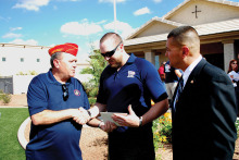 East Valley Marine Pat Rice presents Sgt. Robert Bruce with a certificate for donation from the detachment while Marine Master Sergeant Salvador Marquez of the Wounded Warrior Regiment looks on.