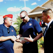 East Valley Marine Pat Rice presents Sgt. Robert Bruce with a certificate for donation from the detachment while Marine Master Sergeant Salvador Marquez of the Wounded Warrior Regiment looks on.