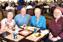 Pastor Vernon and some diners enjoying brats and conversation at last year’s event.