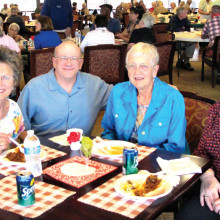 Pastor Vernon and some diners enjoying brats and conversation at last year’s event.