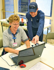 Sun Lakes Fire Department Battalion Chief Rob Helie points out an important part of the flash drive medical forms to CAP member Nancy Roberts.