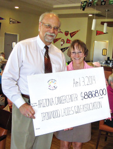 In this 2014 photo, Mark Weiss, Senior Director of Development For Arizona Health Development, accepts our donation from Betty Dupuis.