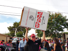 John Van Houten, Maricopa County Toys for Tots chairperson for the past five years, carries an emptied toy box back to the delivery truck.