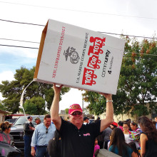 John Van Houten, Maricopa County Toys for Tots chairperson for the past five years, carries an emptied toy box back to the delivery truck.