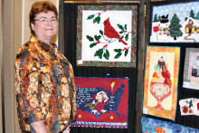 Agave member Linda Diehl carefully examines all of the beautiful President’s Challenge quilts before voting for her favorite.