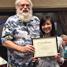 Roger Edmonds presents Uyen Hoang with a $500 check. Hoang was the winner of SLCT’s first ever scholarship.