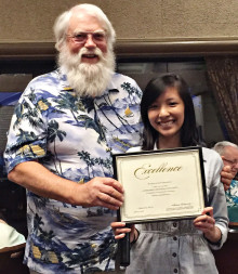 Roger Edmonds presents Uyen Hoang with a $500 check. Hoang was the winner of SLCT’s first ever scholarship.
