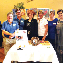A Background of Artwork made by Arizona women prisoners was the setting March 19 for Cottonwood’s Lady Niners’ annual Member-Guest Golf Tournament which raised $7,197 for Gina’s Team. Attending from Gina’s team were (from left) Romelle Durand, Advisory Board; Diane Bondurant, Administrative Assistant; Charlene Clausen, Advisory Board; Sue Ellen Allen, Executive Director; Sandi Starr (third from right); and Diana Morgan (second from right), guest speaker. Representing Lady Niners were Karen Kishpaugh (fourth from right) and Leslie Swan, right, co-chairs of the Member Guest.