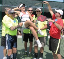 Tom Kasper, David Novikoff, Rich Nadler and David Zapatka carry Cleopatra (JoAnn Zapatka) on her throne to her next match as Mike Mann keeps her cool by fanning her with pickleball paddle fronds!