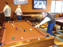 League member Willie Foster playing pool in the Billiards Room at Robson Ranch, Casa Grande, with Keith McDonald and Fritz Derheim in the background.