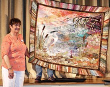 Denny Sullivan shows the Agave Guild her “Great Blue Heron” quilt. This was made in memory of her brother who helped protect a Heron rookery in Vermont several years ago.