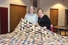 October speaker Shirley Weagant shows one of her beautiful antique quilts to Agave member Susie Seckel.