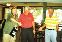 Former VFW Post Commander Neal Peer (right) and current Post Commander Rich Veenhuis (left) present Ron Troyer (center) with a certificate of appreciation.