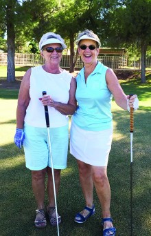 Vicki Carmichael and Nancy Dinkleman play golf in well coordinated, if spontaneous golf clothing!