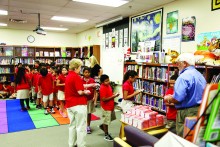 Lion Joyce Davey and Lion Jim Brotherton hand out dictionaries.