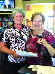 Judi Sloan receives her Hole-in-One winnings from President Karen Beltz