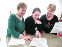 Music Coordinator, Chris Roen, Music Director Dr. Adam Thome’ and Show Manager, Sandra Bocynesky, select the music for their upcoming show.