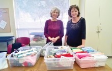 Vicky Buholz and Vickie Benson folded up the material that was left after someone ransacked our cabinet and took a lot of our material. Time to put a lock on it!