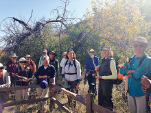 Hike Leader Vicki Deken talks about the life of an early pioneer buried along the trail.