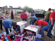 Detachment members (and Marine granddaughter, elf Sarah Garibay) get ready to hand out toys!