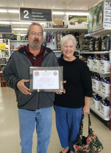 John Rivers, Manager of ACE Hardware in Sun Lakes, receives a plaque of appreciation from Sandra Whittenberg, Chairman of the Veterans and Family Service Program, Sun Lakes VFW Post 8053 Auxiliary.