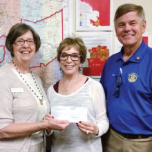 Pictured are Rotarians Terrie Sanders and Steve Perkins presenting a $1,030 check to Ginny Hildebrand, left, the CEO/President of the United Food Bank. The presentation was made April 7 at Food Bank headquarters in Mesa.