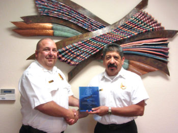 Sun Lakes Fire District Chief Troy Maloney (left) congratulates retiring Deputy Chief Dan Guerra for his service to Sun Lakes. Guerra rose through the ranks including a period when he served as interim chief of the district, but served most of his time as a battalion chief and then deputy chief for the last six years. Before serving in Sun Lakes he served in the Tri-City Fire District in Arizona where he served his last nine years there as assistant chief and also served in the TCFD as acting chief for a period. (Photo by LouAnn Sedgwick; caption by Brian Curry).