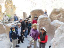 Hikers exploring archeological site in Bandelier National Monument, NM